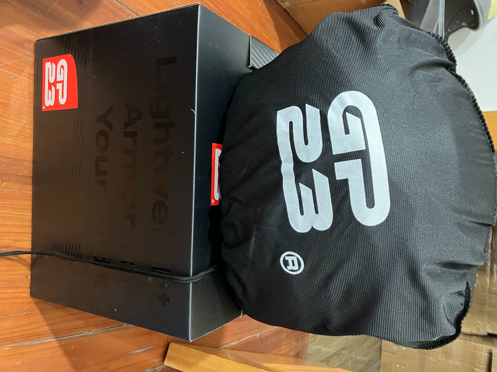 GP23 branded helmet bag beside the finished box with glossy black lettering