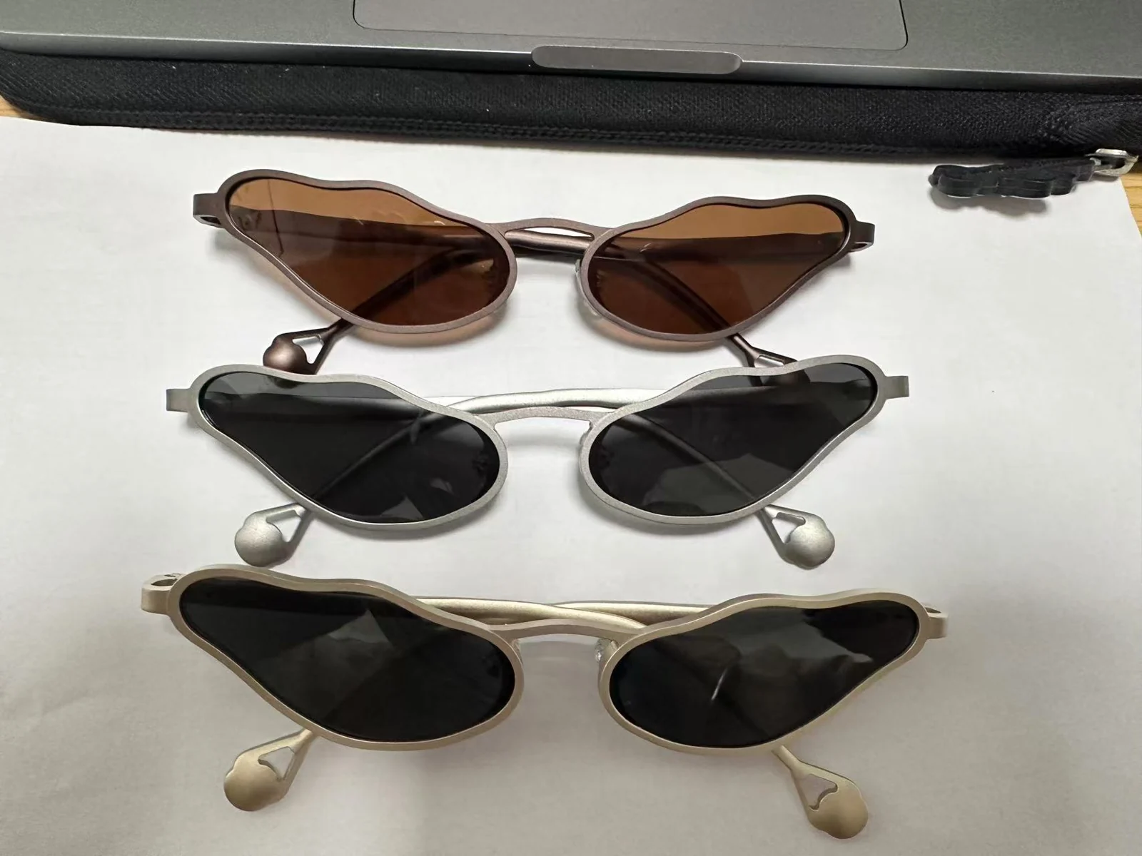Three assembled eyewear samples with the organic silhouette in different frame and lens finishes