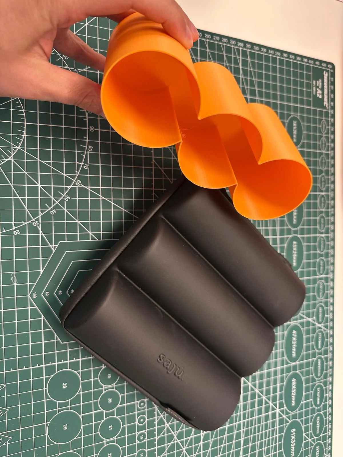Tris Case prototype held beside a case shell